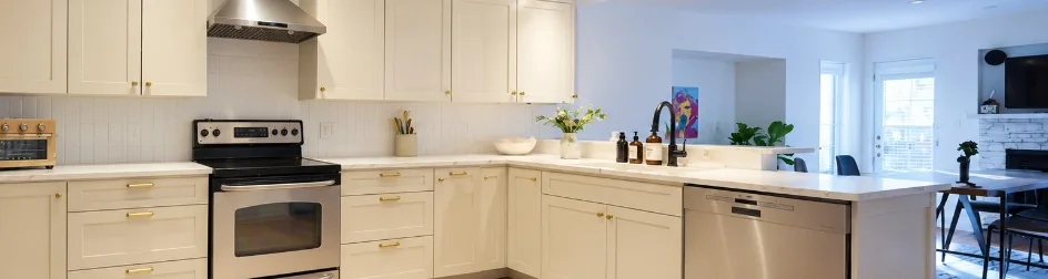 The same kitchen after a sprayed white cabinet refinish, by Merner's Painting & Decorating in Houston, TX