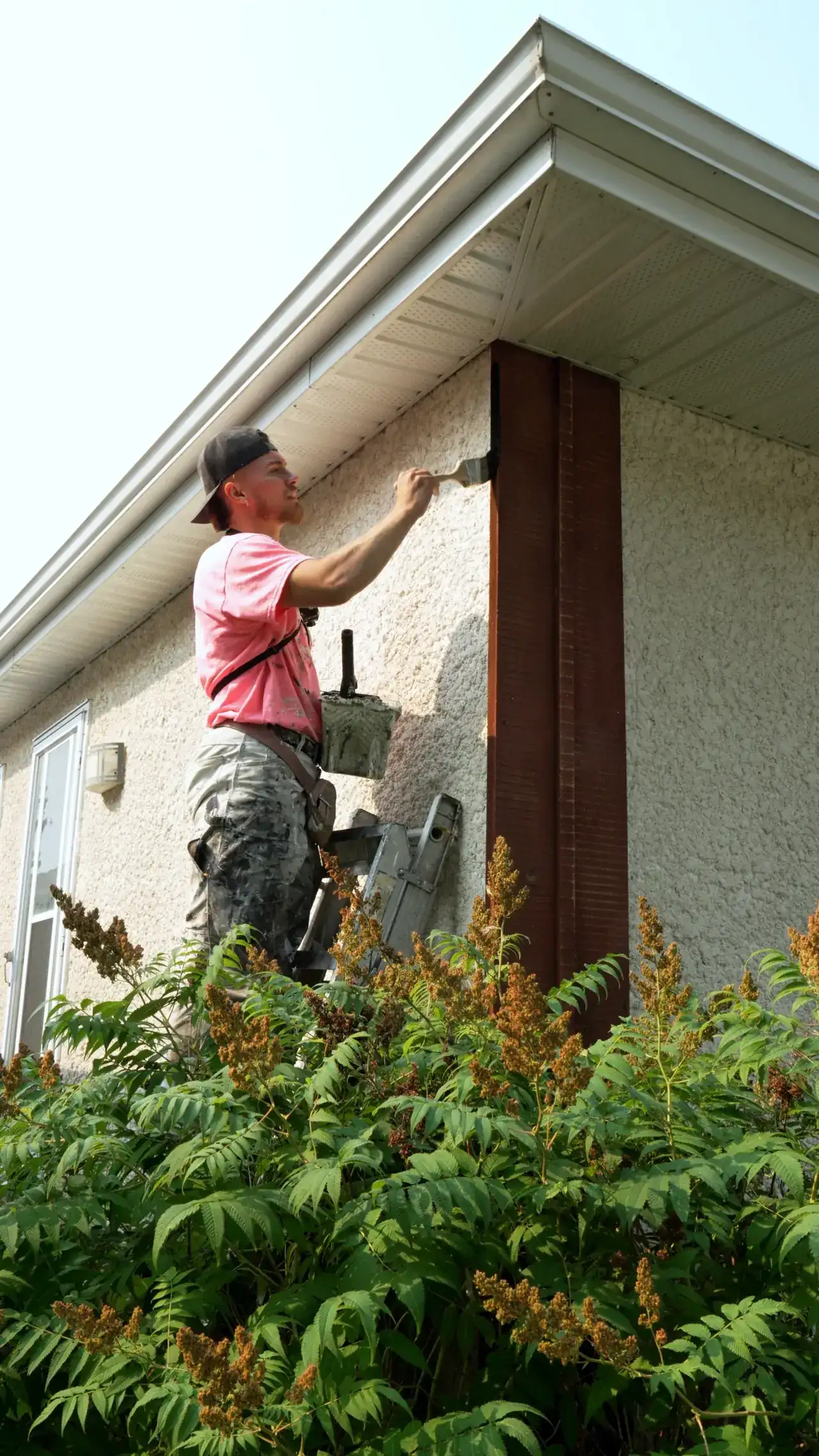 Merner's Painting & Decorating painter finishing exterior trim on a Houston, TX home