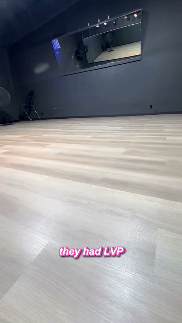 Commercial gym interior with charcoal walls and luxury vinyl plank flooring in Houston, TX